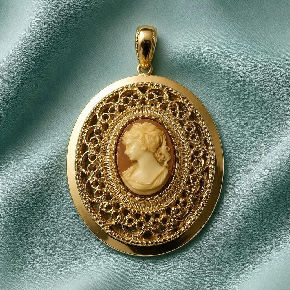 Gold tone Cameo locket and pink color.